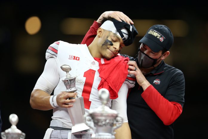 Clemson Tigers head coach Dabo Swinney embraces quarterback Justin Fields (1) after defeating the Clemson Tigers during the second half at Mercedes-Benz Superdome.