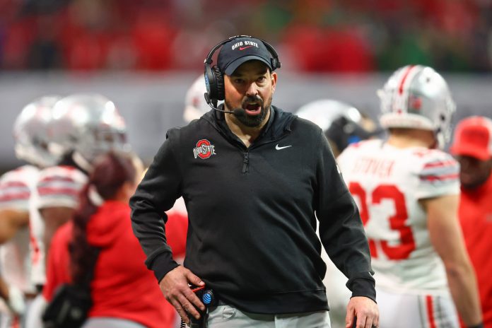 Ohio State Buckeyes head coach Ryan Day reacts after a play against the Notre Dame Fighting Irish during the second half the CFP National Championship college football game at Mercedes-Benz Stadium.