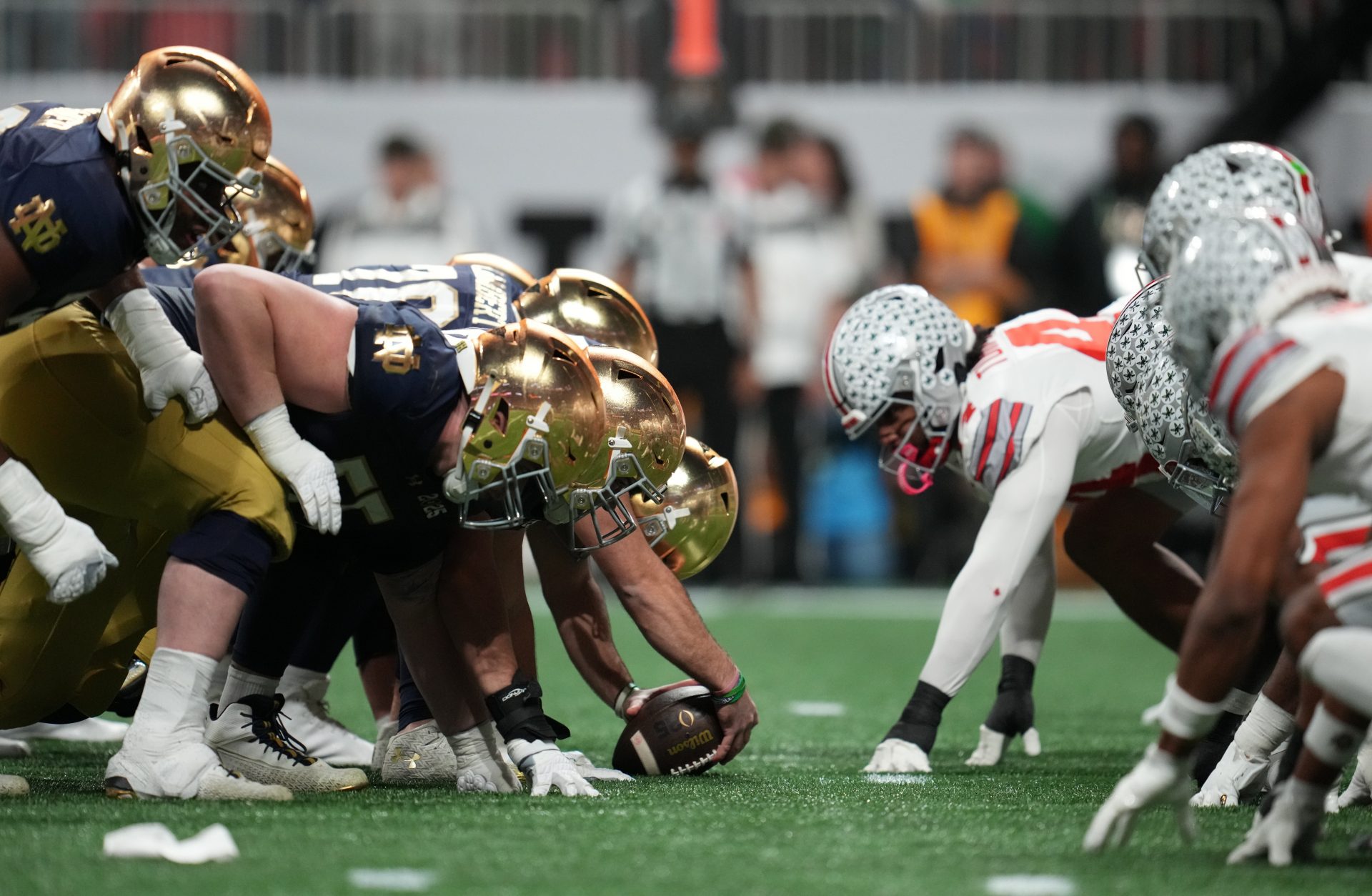 Notre Dame Fighting Irish offense lines up against the Ohio State Buckeyes defense in the CFP National Championship college football game at Mercedes-Benz Stadium.