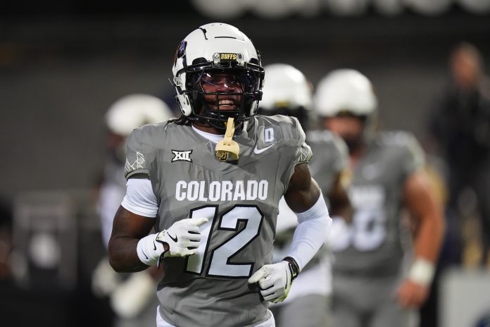 Colorado Buffaloes wide receiver Travis Hunter (12) reacts after touchdown reception in the first quarter against the Cincinnati Bearcats at Folsom Field.