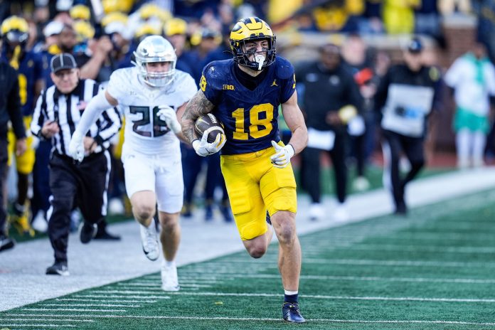 Michigan tight end Colston Loveland (18) runs against Oregon linebacker Bryce Boettcher (28) during the first half at Michigan Stadium in Ann Arbor on Saturday, Nov. 2, 2024.