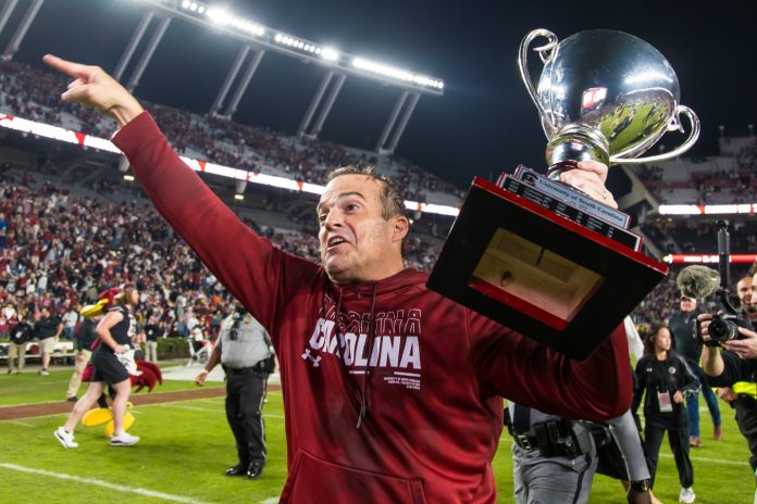 South Carolina Gamecocks head coach Shane Beamer celebrates beating the Missouri Tigers at Williams-Brice Stadium. He is holding the Mayors Cup, given to the winner of the South Carolina-Missouri game.