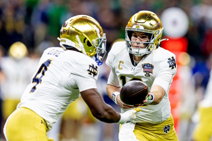 Notre Dame Fighting Irish running back Jeremiyah Love (4) hands the ball to Notre Dame Fighting Irish quarterback Riley Leonard (13) during the first quarter at Caesars Superdome.