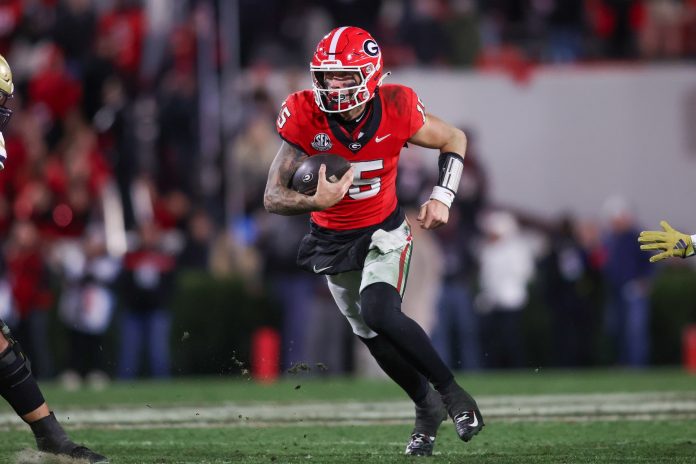 Georgia Bulldogs quarterback Carson Beck (15) runs the ball against the Georgia Tech Yellow Jackets in the fourth quarter at Sanford Stadium.