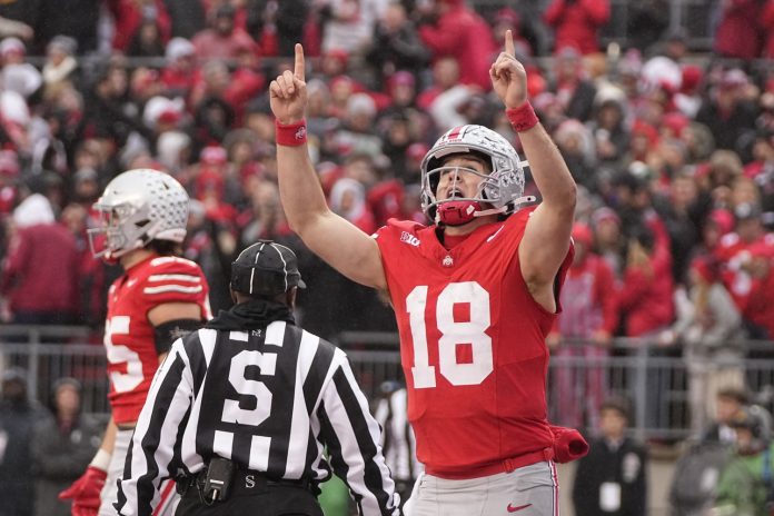 Ohio State Buckeyes quarterback Will Howard (18) celebrates a touchdown during the first half of the NCAA football game against the Indiana Hoosiers at Ohio Stadium in Columbus on Saturday, Nov. 23, 2024.