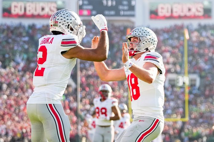 Ohio State Buckeyes wide receiver Emeka Egbuka (2) celebrates a touchdown catch with quarterback Will Howard (18) during the first half of the College Football Playoff quarterfinal against the Oregon Ducks at the Rose Bowl in Pasadena, Calif. on Jan. 1, 2025.