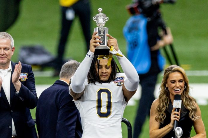 Notre Dame Fighting Irish safety Xavier Watts (0) holds up the Sugar Bowl outstanding defensive player trophy after the game against the Georgia Bulldogs at Caesars Superdome.