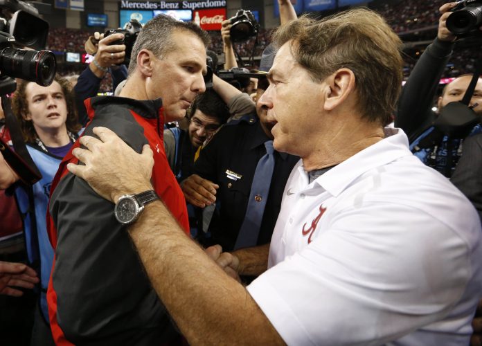 Ohio State Buckeyes head coach Urban Meyer and Alabama Crimson Tide head coach Nick Saban greet each other after the 2015 Sugar Bowl at Mercedes-Benz Superdome. Ohio State defeated Alabama 42-35.