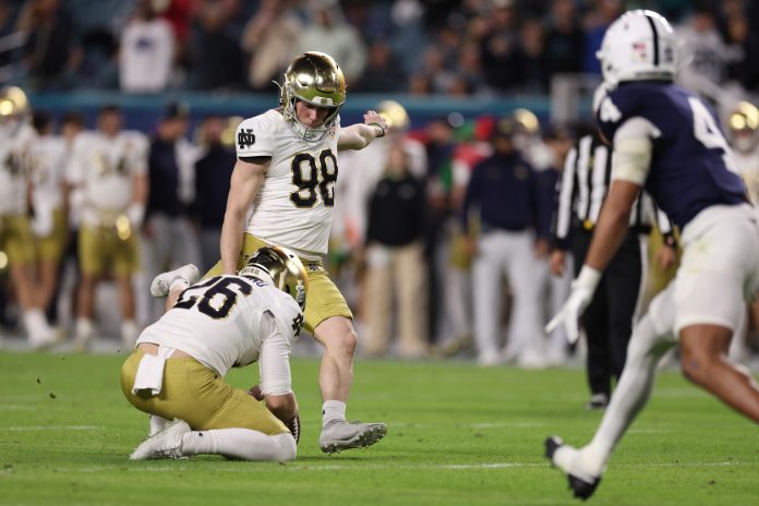 Notre Dame Fighting Irish place kicker Mitch Jeter (98) kicks the ball in the second half against the Penn State Nittany Lions in the Orange Bowl at Hard Rock Stadium.