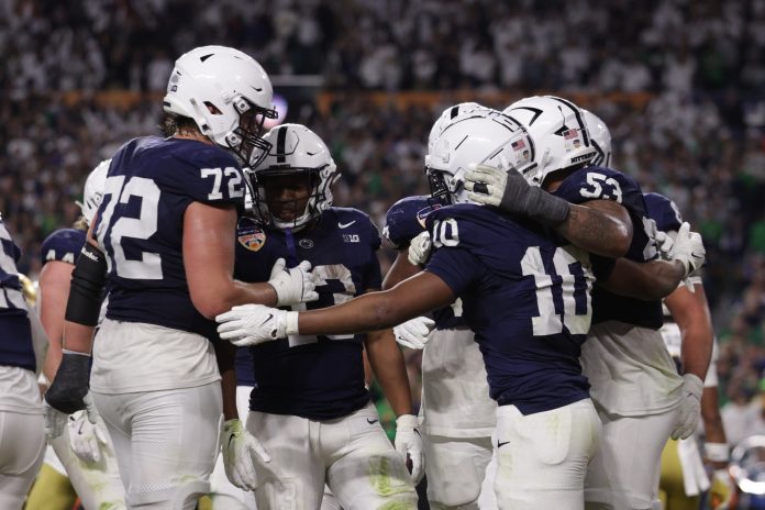 Penn State Nittany Lions running back Nicholas Singleton (10) celebrates a touch down with teammates in the first half against the Notre Dame Fighting Irish in the Orange Bowl at Hard Rock Stadium.