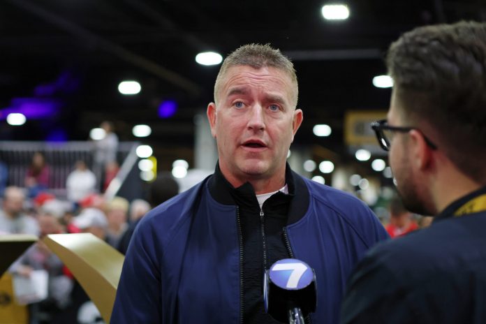 Kirk Herbstreit talks to the media during 2025 CFP National Championship Media Day at Georgia World Congress Center, Building A