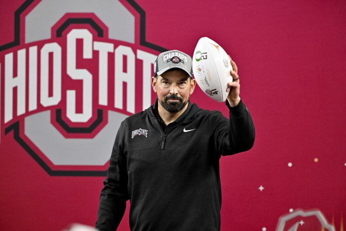 Ohio State Buckeyes head coach Ryan Day holds up the game ball after the Buckeyes defeat the Texas Longhorns at AT&T Stadium.