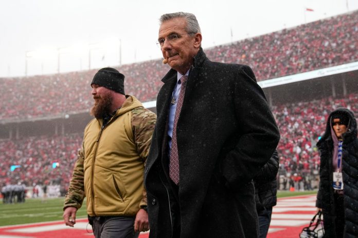 Former Ohio State Buckeyes coach Urban Meyer walks across the field during the NCAA football game against the Indiana Hoosiers at Ohio Stadium in Columbus on Monday, Nov. 25, 2024. Ohio State won 38-15.