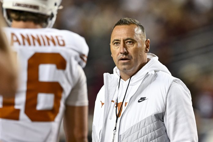 Texas Longhorns head coach Steve Sarkisian speaks with quarterback Arch Manning (16) during warm ups against the Texas A&M Aggies at Kyle Field.