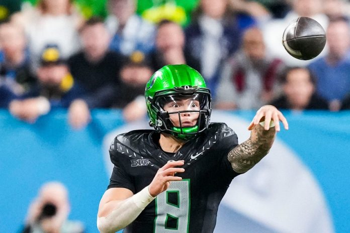 Oregon Ducks quarterback Dillon Gabriel (8) throws a pass Saturday, Dec. 7, 2024, during the Big Ten Championship game between the Oregon Ducks and the Penn State Nittany Lions at Lucas Oil Stadium in Indianapolis. The Ducks defeated the Nittany Lions, 45-37.