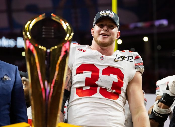 Ohio State Buckeyes defensive end Jack Sawyer (33) celebrates after defeating the Notre Dame Fighting Irish in the CFP National Championship college football game at Mercedes-Benz Stadium.