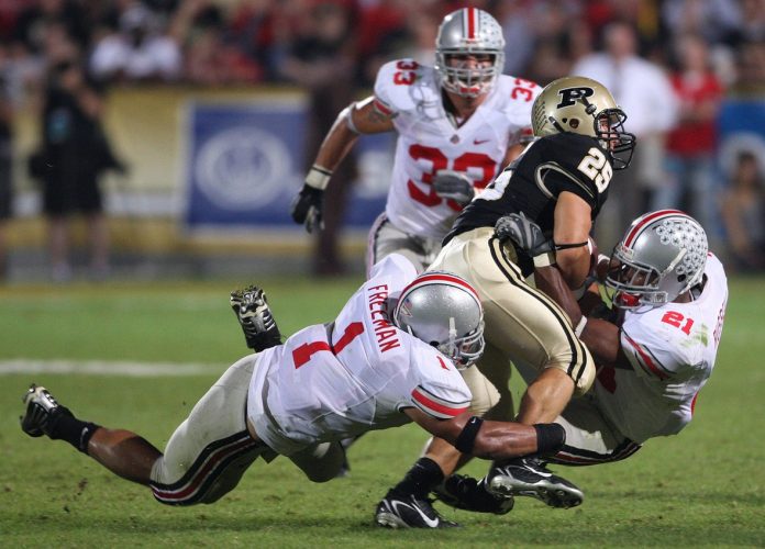 Ohio State's Marcus Freeman, 1, and teammate Anderson Russell, 21, team up to stop Purdue's Dan Dierking, 25, in the second half of their game at Ross-ADE Stadium, October 6, 2007. (Dispatch photo by Neal C. Lauron)