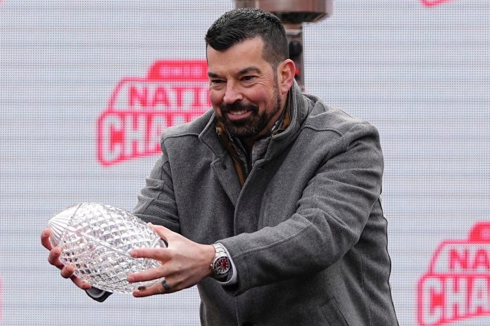 Ohio State Buckeyes head coach Ryan Day holds the Coaches' Trophy during the Ohio State Buckeyes College Football Playoff National Championship celebration at Ohio Stadium in Columbus on Jan. 26, 2025.