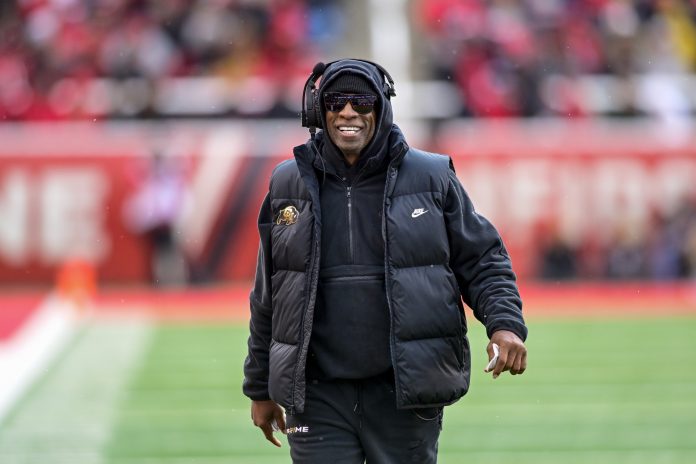 Colorado Buffaloes head coach Deion 'Coach Prime' Sanders on the field against the Utah Utes at Rice-Eccles Stadium.