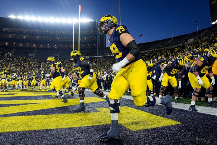 Michigan offensive lineman Jeffrey Persi (79) warms up with his group before the Michigan State game at Michigan Stadium in Ann Arbor on Saturday, Oct. 26, 2024.