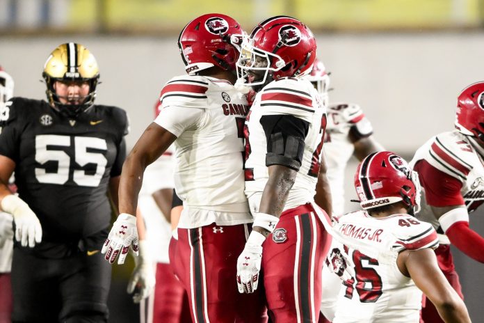 South Carolina Gamecocks linebacker Bam Martin-Scott (22) celebrates the sack of Vanderbilt Commodores quarterback Diego Pavia (2) with defensive back Nick Emmanwori (7) at FirstBank Stadium.