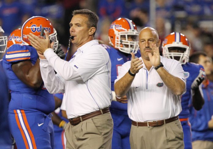 Florida Gators head coach Urban Meyer and offensive coordinator Steve Addazio during pregame of the game against the South Carolina Gamecocks at Ben Hill Griffin Stadium.