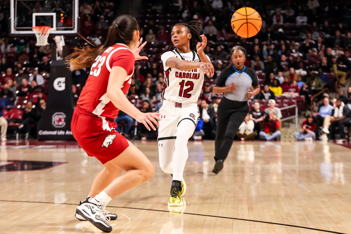 South Carolina Gamecocks guard MiLaysia Fulwiley (12) makes a no-look pass past Arkansas Razorbacks guard Carly Keats (23) in the first half at Colonial Life Arena.