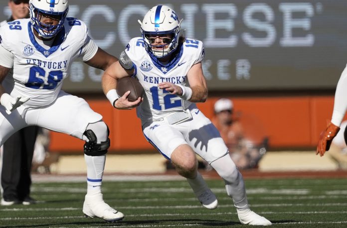 Kentucky Wildcats quarterback Brock Vandagriff (12) runs during the first half against the Texas Longhorns at Darrell K Royal-Texas Memorial Stadium.