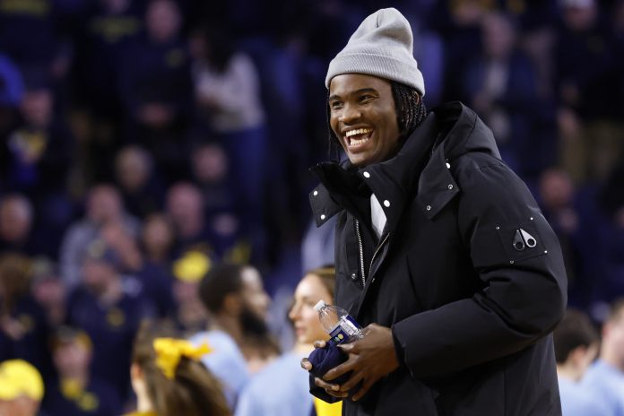 Michigan Wolverines quarterback Bryce Underwood participates in a t-shirt toss during a time out in the second half against the Penn State Nittany Lions at Crisler Center.