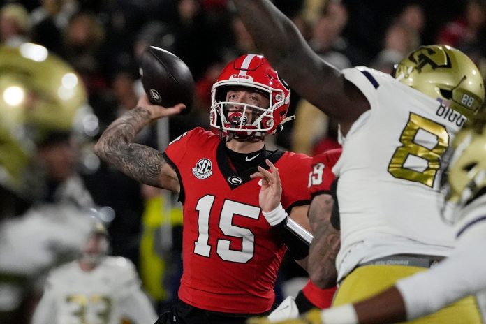 Georgia quarterback Carson Beck (15) throws the ball during the first half of a NCAA college football game against Georgia Tech in Athens, Ga., on Friday, Nov. 29, 2024.