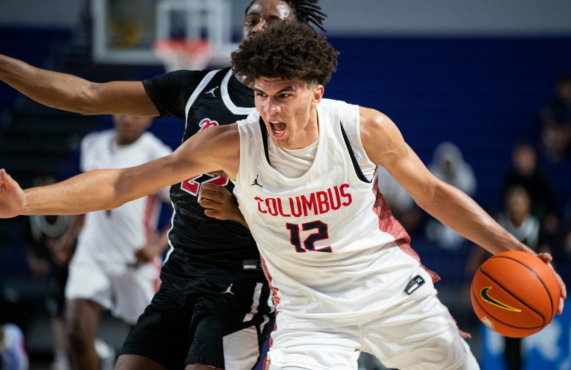 Columbus Explorers forward Cameron Boozer (12) drives to the basket against Archbishop Ryan Raiders forward Jaden Murray (22) during the third quarter of a game during the 50th annual City of Palms Classic at Suncoast Credit Union Arena in Fort Myers on Tuesday, Dec. 19, 2023.