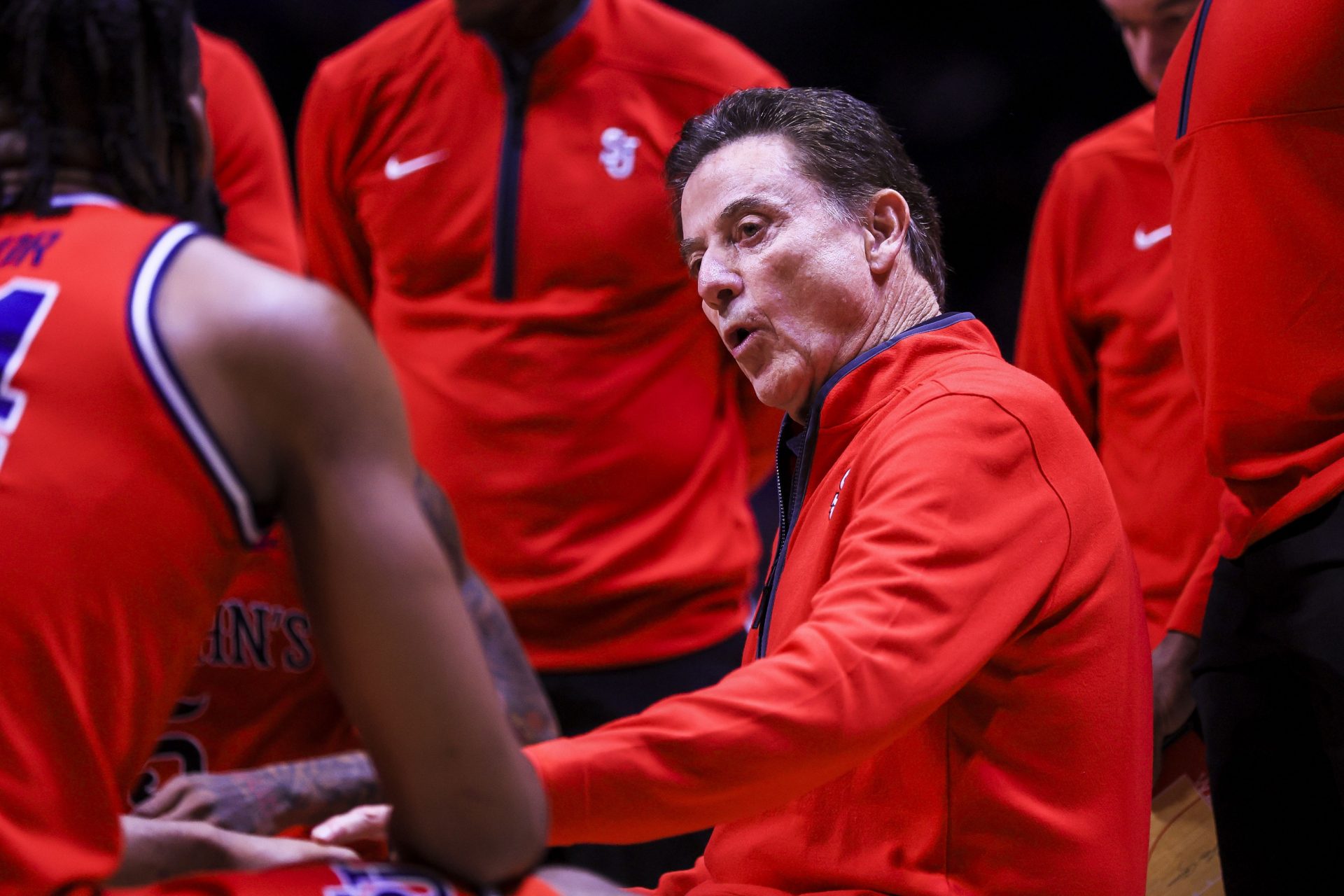 St. John's Red Storm head coach Rick Pitino talks to his team during a timeout in the first half against the Xavier Musketeers at Cintas Center.