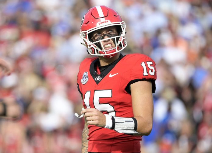 Georgia Bulldogs quarterback Carson Beck (15) reacts after throwing an interception against the Florida Gators during the first quarter at EverBank Stadium.