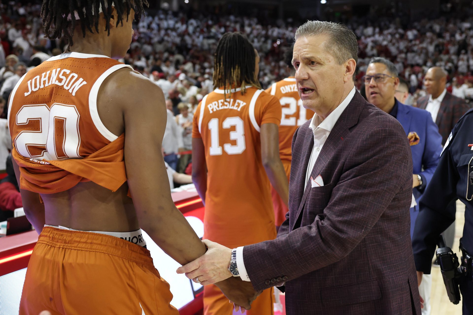 Arkansas Razorbacks head coach John Calipari shakes hands with Texas Longhorns guard Tre Johnson after the game at Bud Walton Arena.