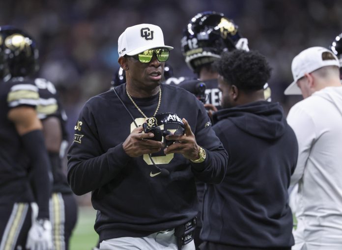 Colorado Buffaloes head coach Deion Sanders walks on the field between plays during the first quarter against the Brigham Young Cougars at Alamodome.