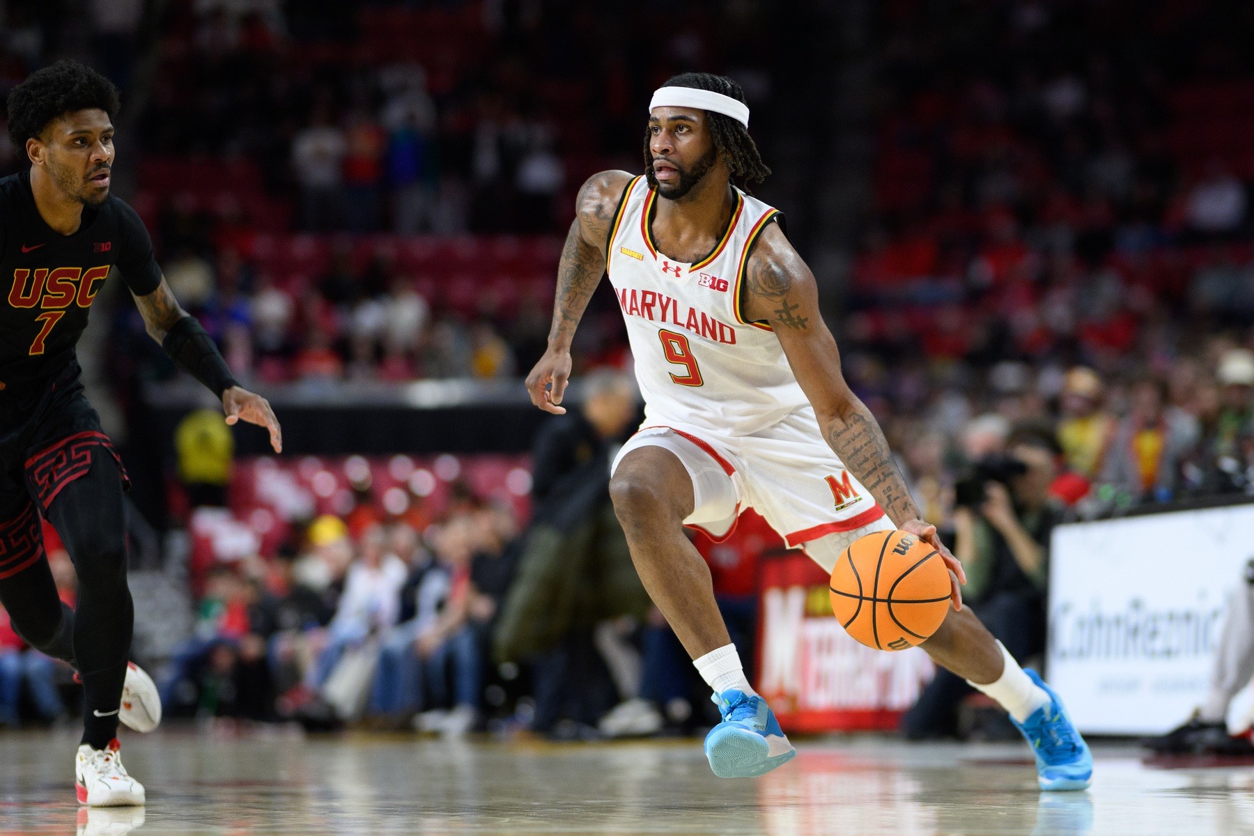 Maryland Terrapins guard Selton Miguel (9) drives to the basket against USC Trojans guard Chibuzo Agbo (7) during the second half at Xfinity Center.