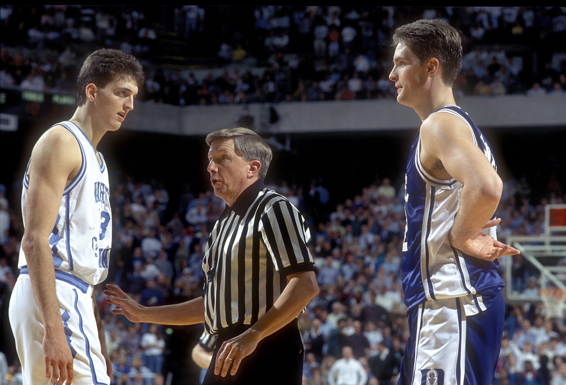 North Carolina Tar Heels center Kevin Salvadori looks at Duke Blue Devils center Christian Laettner (32) in the Tar Heels 75-73 victory against the Blue Devils at the Dean E. Smith Center. Montross is playing with a cut below his left eye.