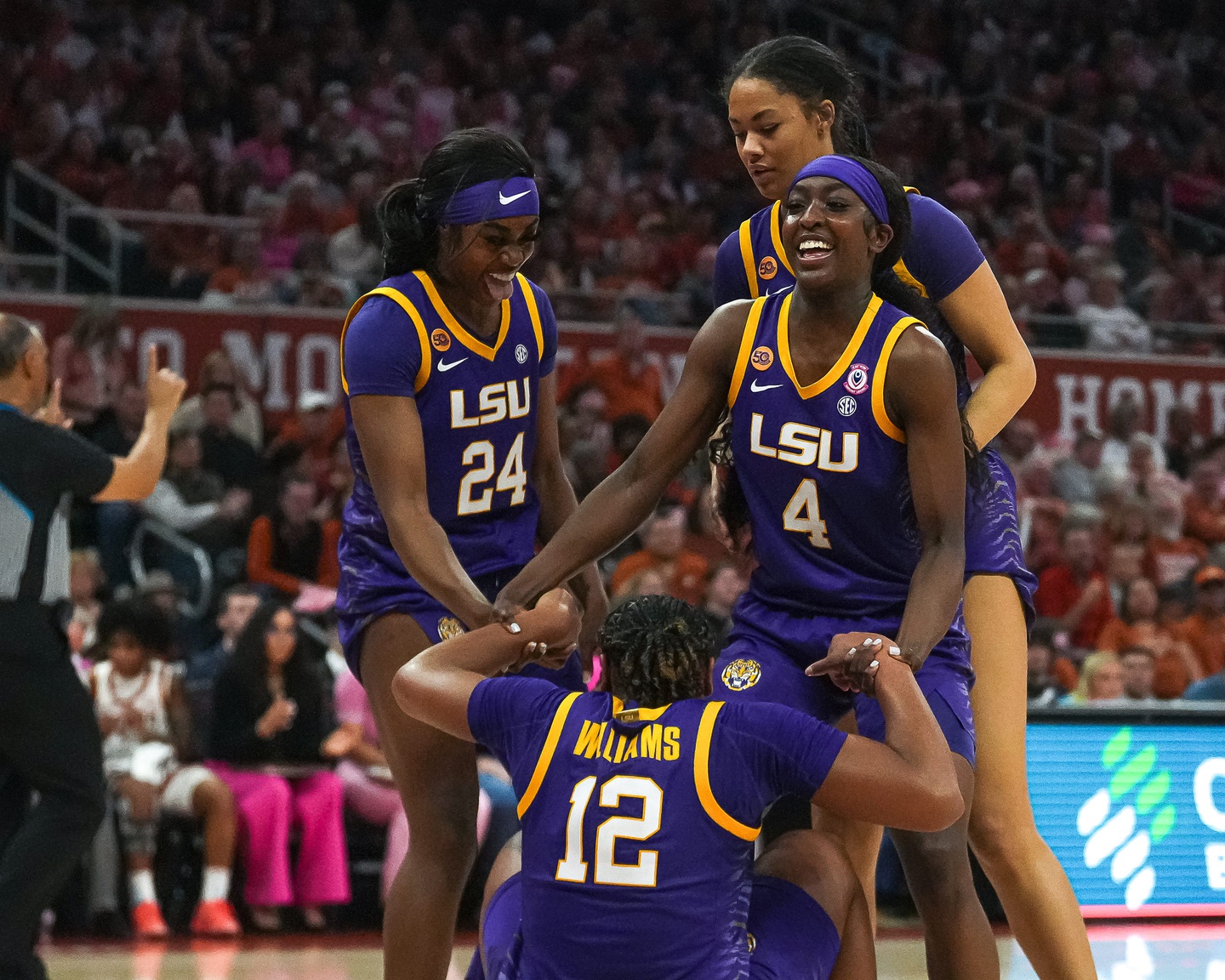 LSU guard Flau'Jae Johnson (4) helps up guard Mikaylah (12) after drawing a foul during the game against the Texas Longhorns at the Moody Center on Sunday, Feb. 16, 2025.