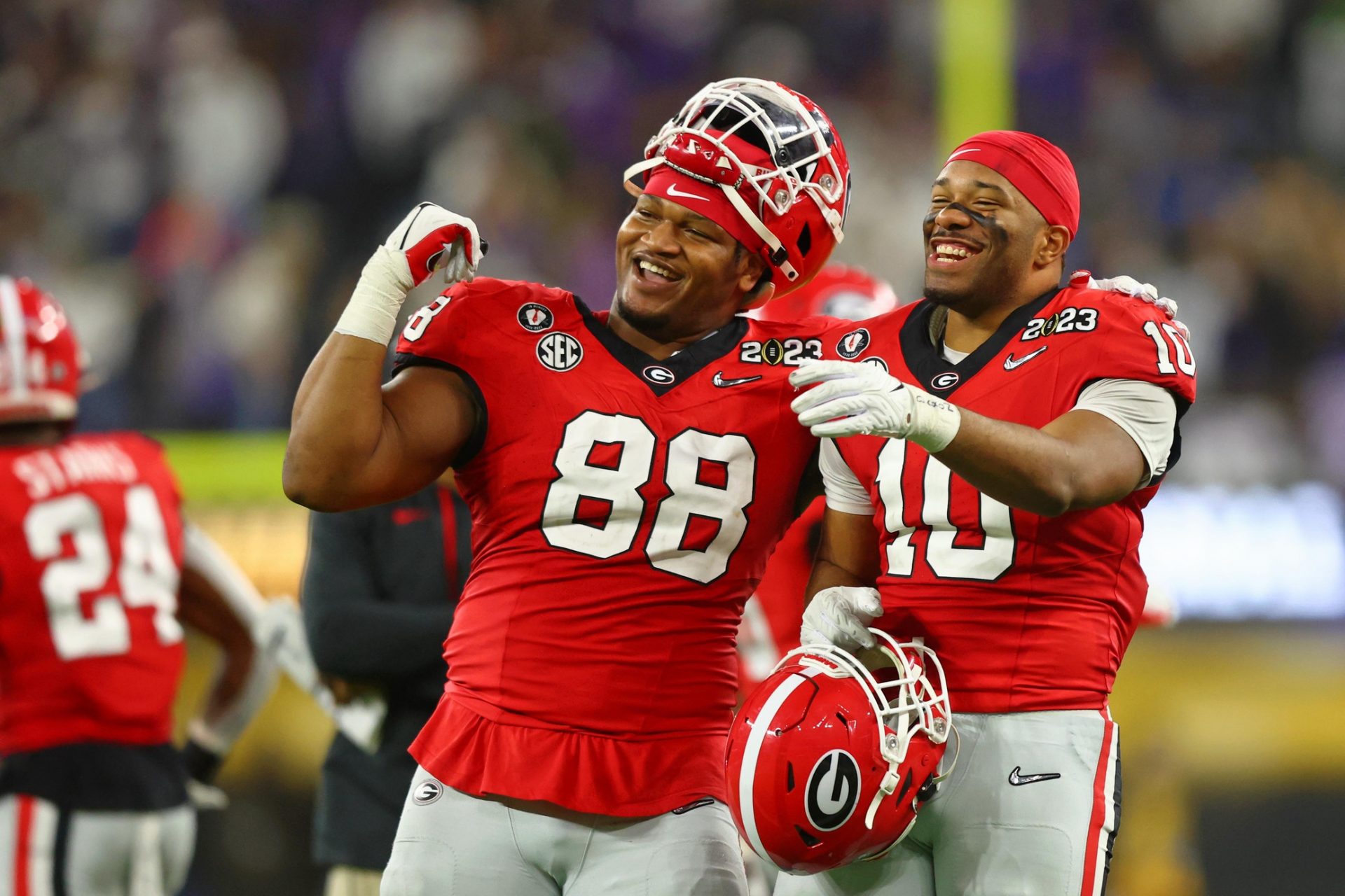 Georgia Bulldogs defensive lineman Jalen Carter (88) and linebacker Jamon Dumas-Johnson (10) react after a play against the TCU Horned Frogs during the fourth quarter of the CFP national championship game at SoFi Stadium.