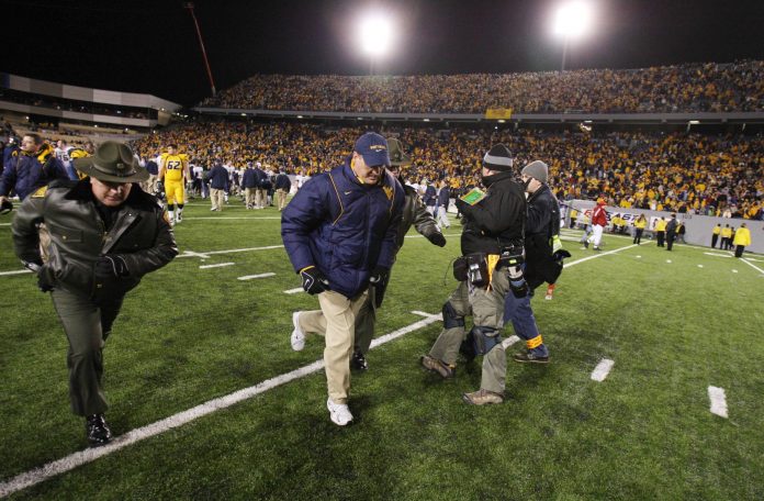 West Virginia Mountaineer head coach Rich Rodriguez leaves the field after the Mountaineers 13-9 loss to the Pittsburgh Panthers at Mylan Puskar Stadium. Duhart recovered the fumble.