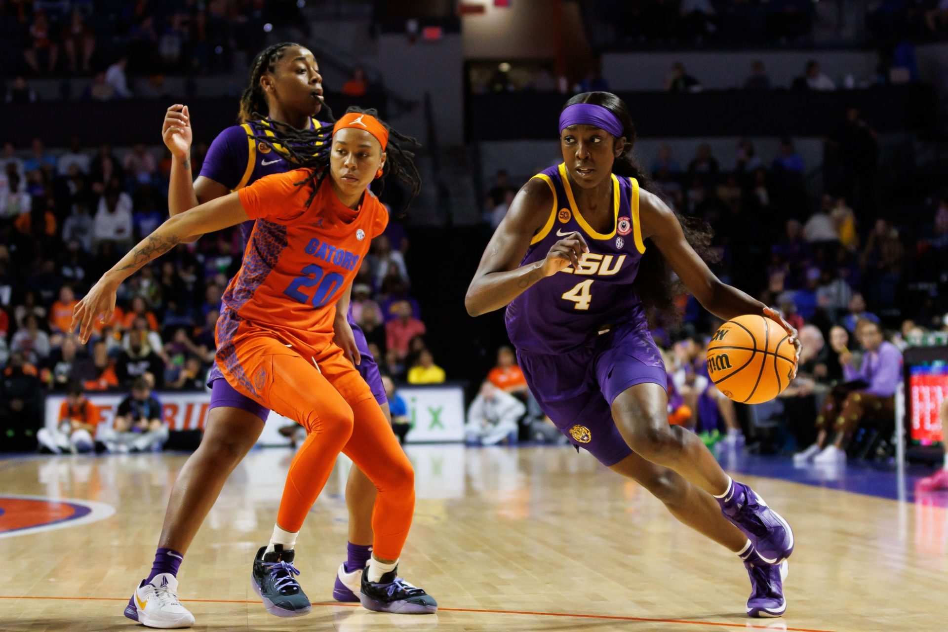 LSU Tigers guard Flau'Jae Johnson (4) drives to the basket after LSU Tigers guard Mikaylah Williams (12) screens Florida Gators guard Jeriah Warren (20) during the first half at Exactech Arena at the Stephen C. O'Connell Center.