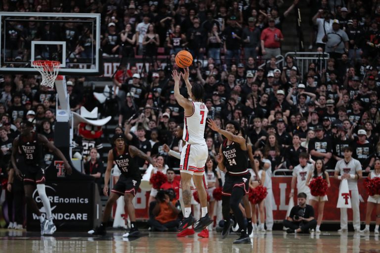 Houston Cougars guard Milos Uzan (7) makes a jump shot in front of Texas Tech Red Raiders guard Kerwin Walton (24) in the second half at United Supermarkets Arena.