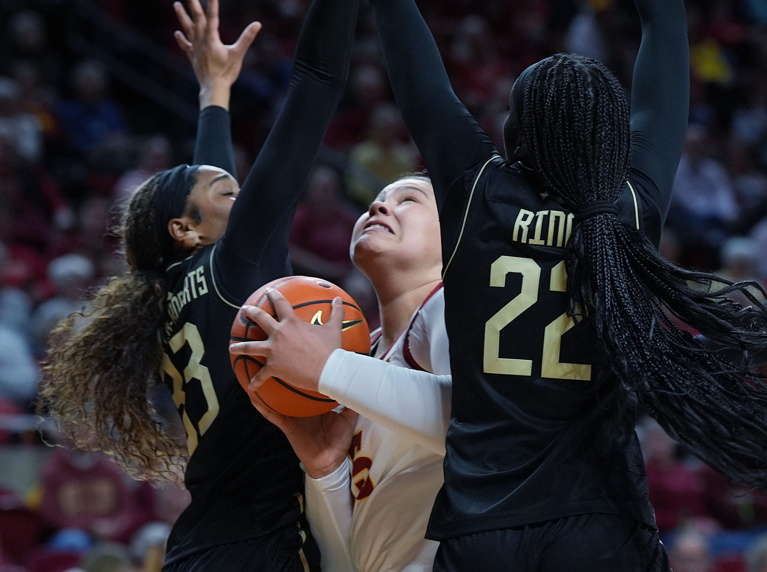 Iowa State Cyclones' center Audi Crooks (55) looks for a shot between UCF Knights forward Mahogany Chandler- Roberts (33) and forward Adeang Ring (22) during the second quarter in the Big-12 women’s basketball at Hilton Coliseum on Saturday, Jan. 25, 2025, in Ames, Iowa.