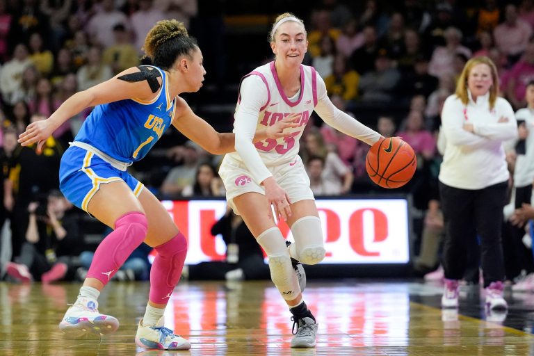 Iowa guard Lucy Olsen (33) brings the ball up court as UCLA guard Kiki Rice (1) defends Sunday, Feb. 23, 2025 at Carver-Hawkeye Arena in Iowa City, Iowa.