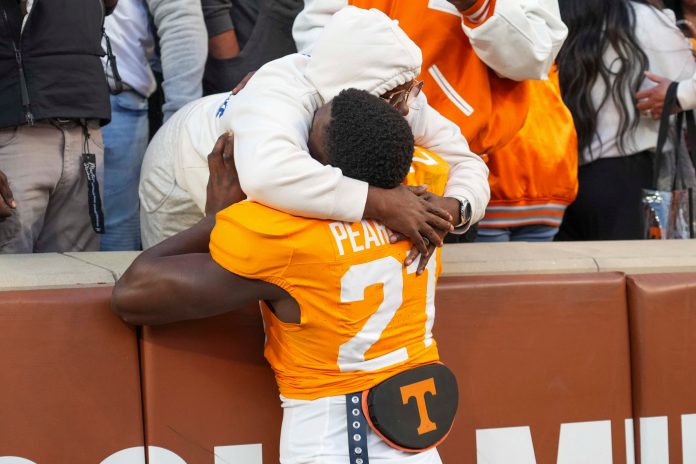 Tennessee defensive lineman James Pearce Jr. (27) hugs a family member after winning a NCAA football game between Tennessee and UTEP in Neyland Stadium on Saturday, November 23, 2024.