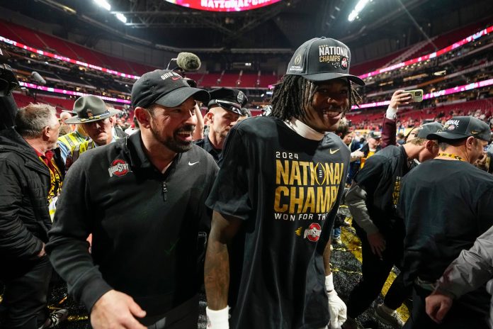 Ohio State Buckeyes head coach Ryan Day and Ohio State Buckeyes wide receiver Jeremiah Smith (4) leave the field following the 34-23 win over the Notre Dame Fighting Irish to win the College Football Playoff National Championship at Mercedes-Benz Stadium in Atlanta on Jan. 21, 2025.