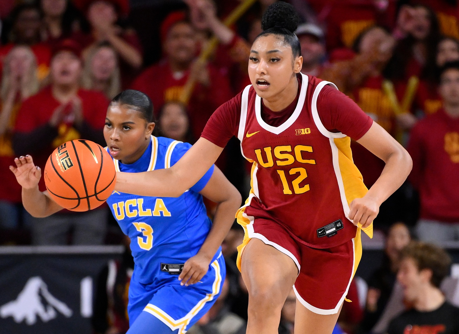 USC Trojans guard JuJu Watkins (12) dribbles past UCLA Bruins guard Londynn Jones (3) during an NCAA basketball game at Galen Center.