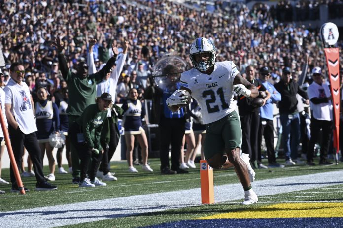 Tulane Green Wave running back Makhi Hughes (21) scores a touchdown during the first half against the Navy Midshipmen at Navy-Marine Corps Memorial Stadium.