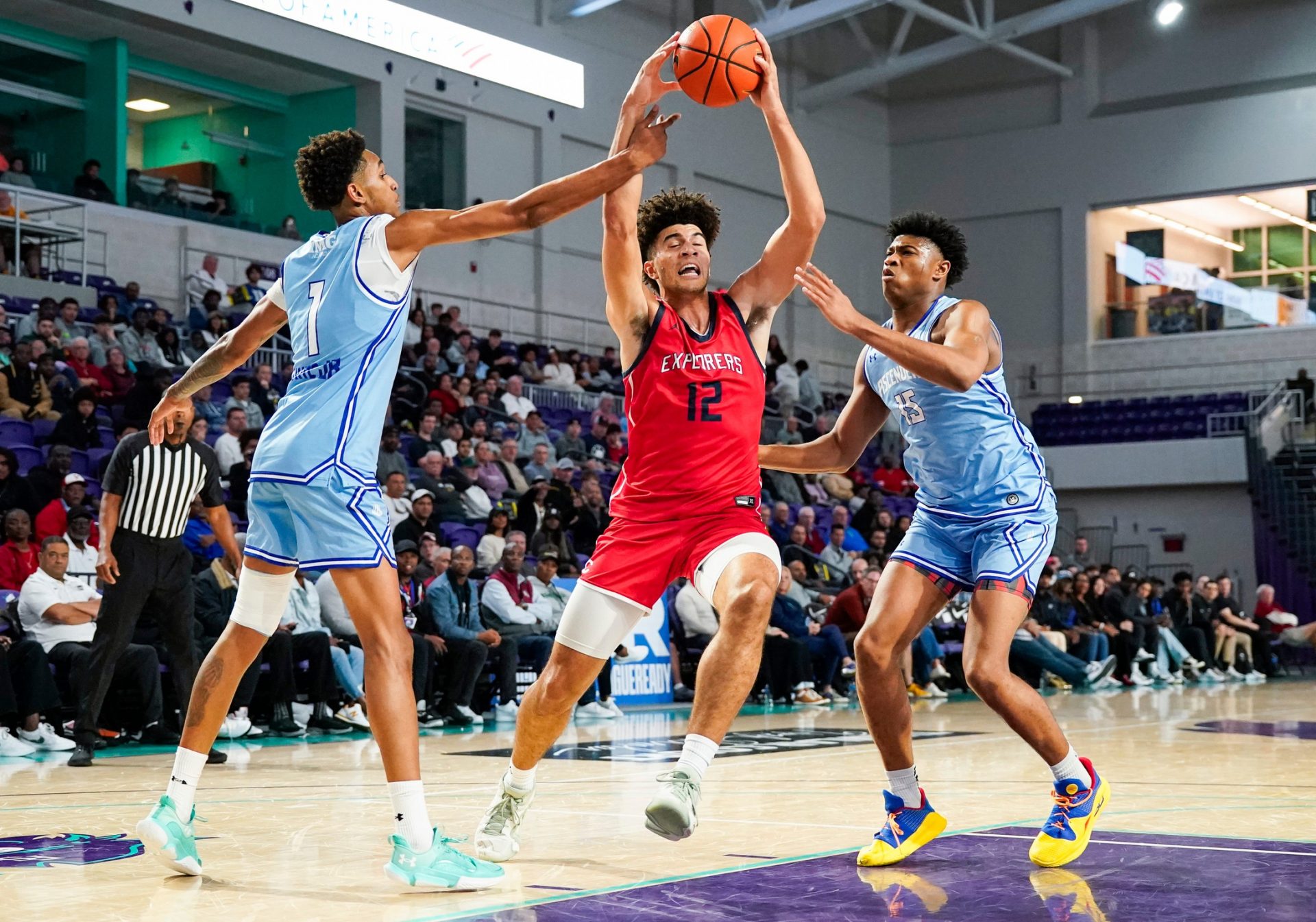 Columbus Explorers forward Cameron Boozer (12) is fouled by IMG Academy Ascenders forward Sadiq White Jr. (1) during the first quarter of the City of Palms Classic semifinal game at Suncoast Credit Union Arena in Fort Myers, Fla., on Saturday, Dec. 21, 2024.