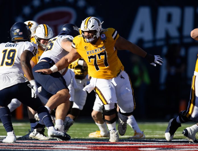 Wyoming Cowboys center Nofoafia Tulafono (77) against the Toledo Rockets during the Arizona Bowl at Arizona Stadium.